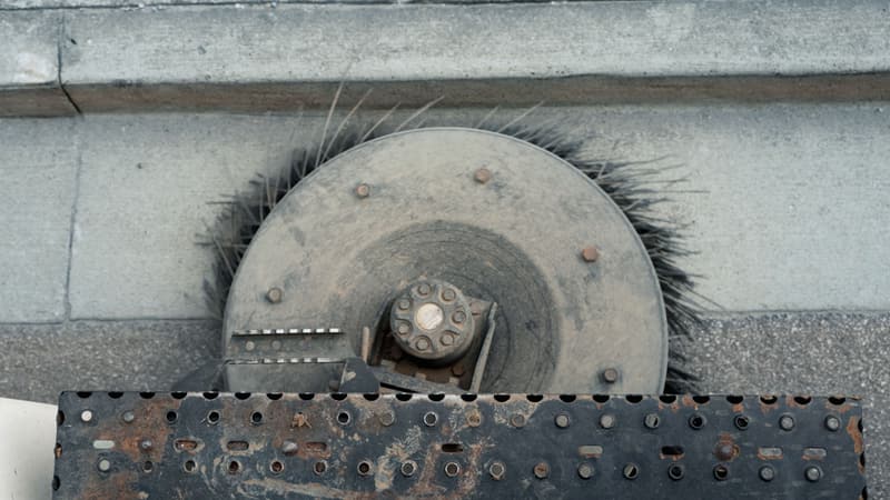 Close-up of a sweeper truck broom head